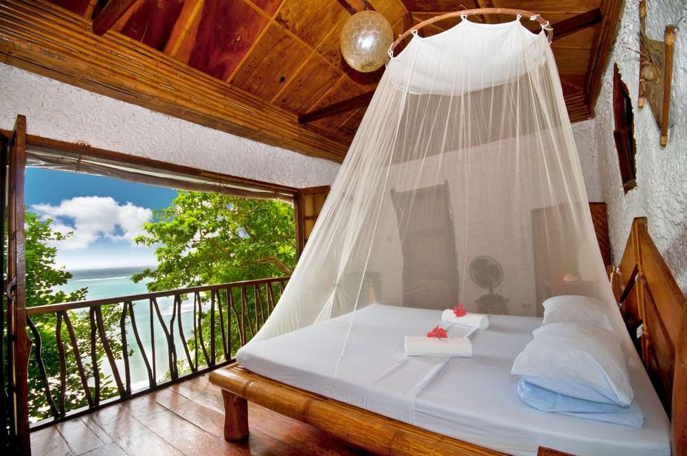 Canopy bed with sea view at a tropical resort